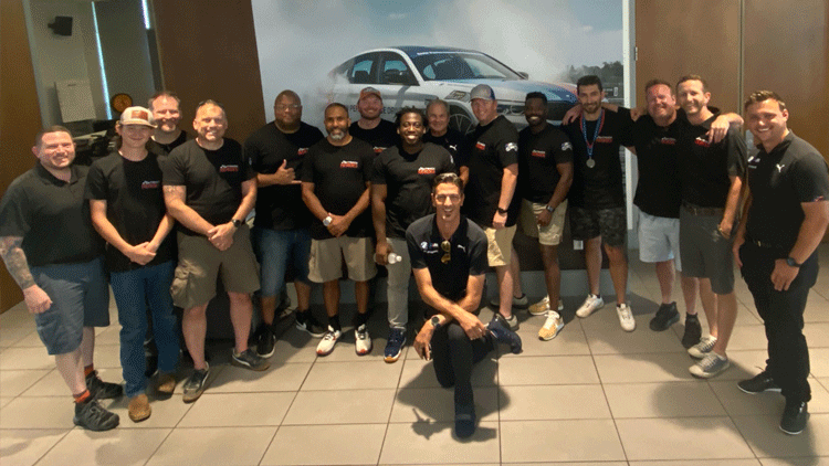 a group of men pose for a photo at a Track Heroes event